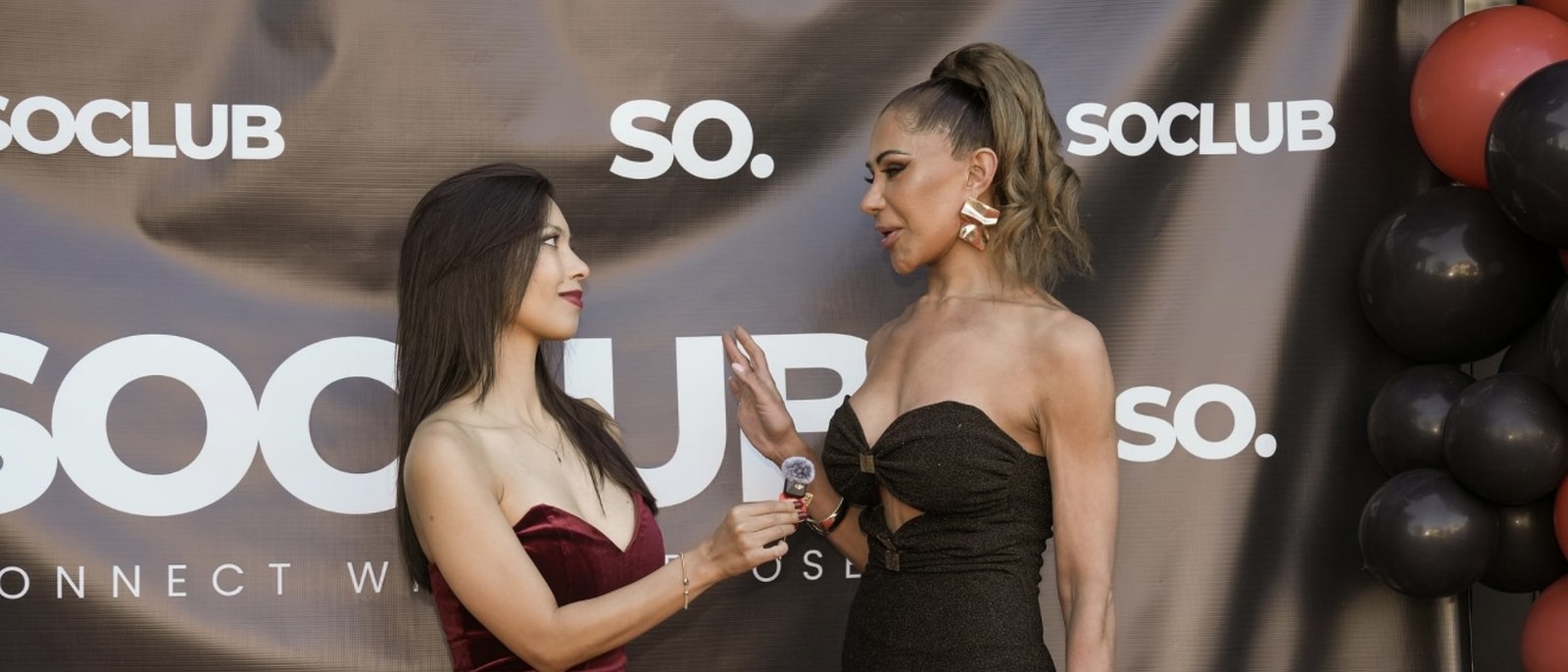 Rachel Dragas conducting a red carpet interview on microphone at the SOCLUB event, Toronto